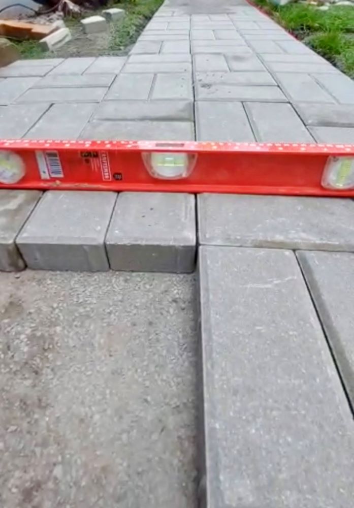 precision leveling of interlock pavers during walkway installation