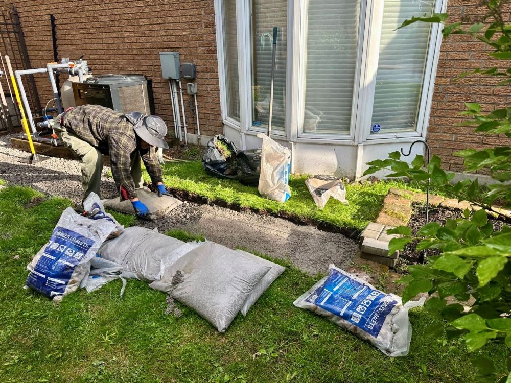 professional gravel base preparation before interlock installation.