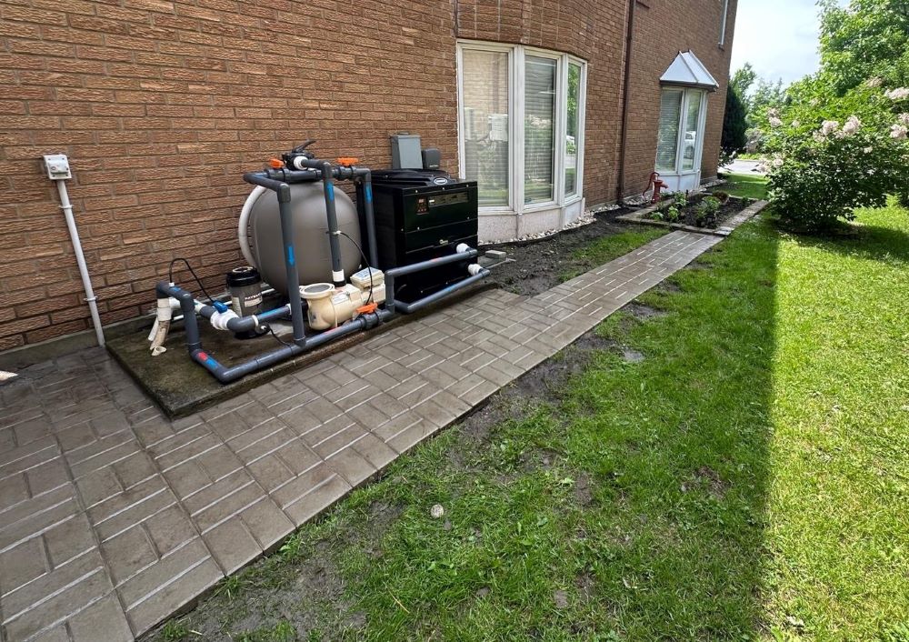 Completed interlock walkway installation with professional paver design and landscaping restoration in Montreal.